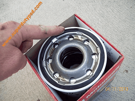 coating new oil filter gasket with oil
